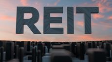 3d rendering of the acronym REIT above a cityscape